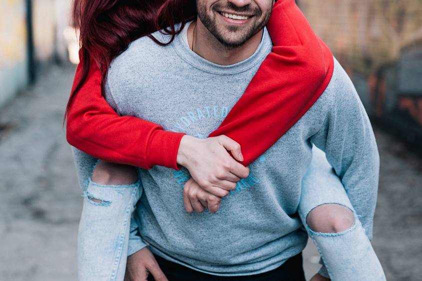 Young man carrying young woman on his back