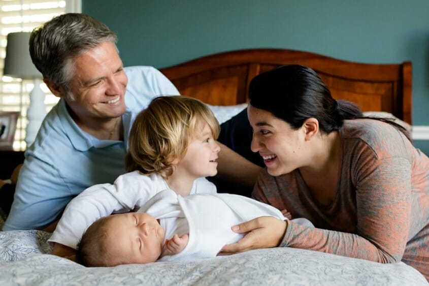 Happy parents with toddler and baby