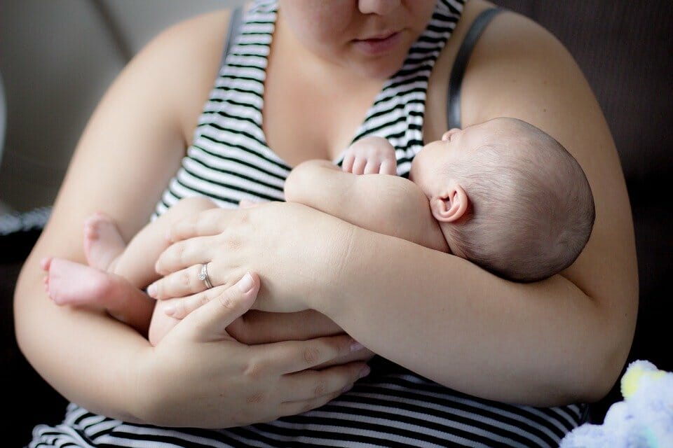 Mother hugging her sleeping baby