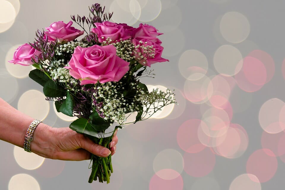 Hand holding a bouquet of flowers