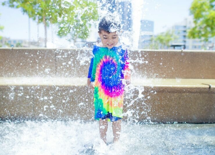 Happy boy in a water fountain