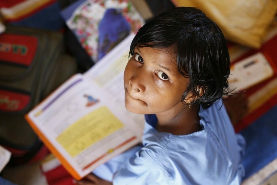 Girl looking up from school work