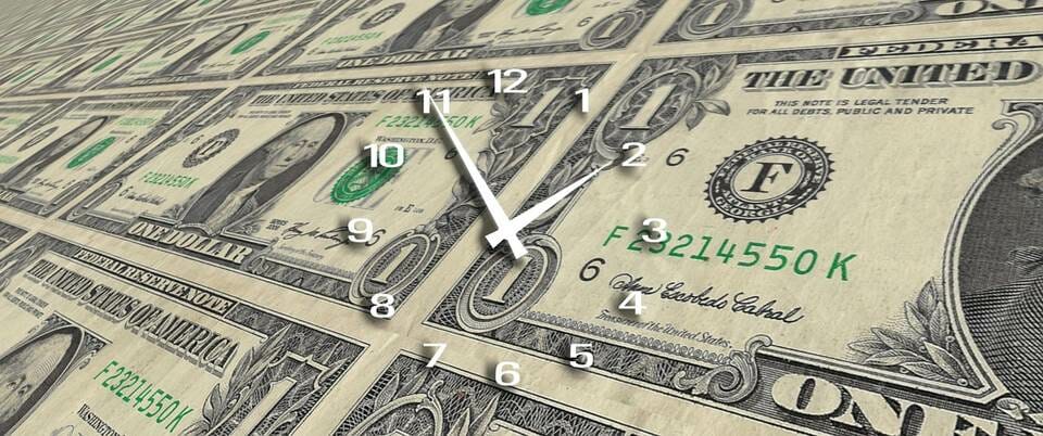 Clock over one dollar notes
