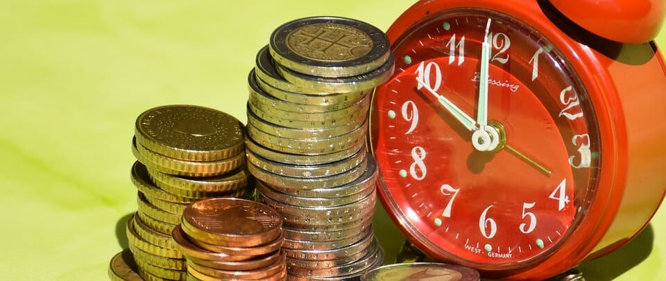 Clock and stacks of coins