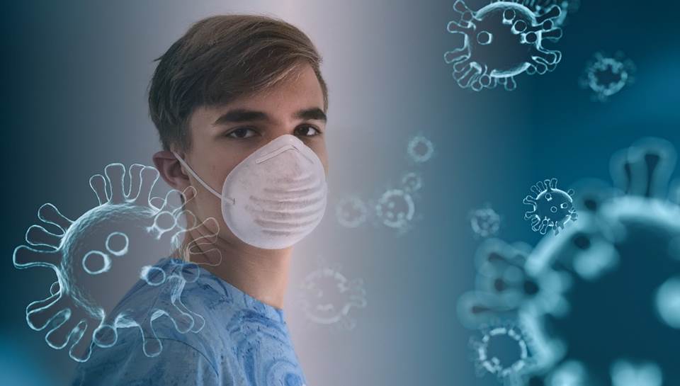 Teenage boy with a surgical mask surrounded by viruses