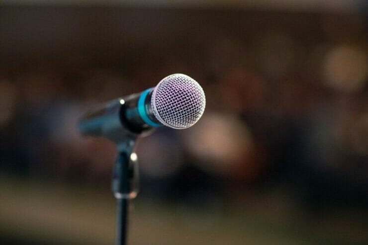 Microphone and blurred audience - the fear of public speaking