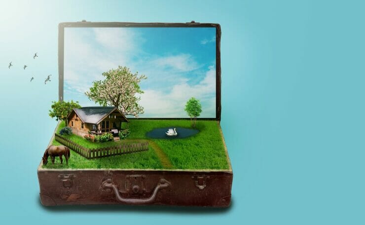 Staycation: suitcase with a laptop screen containing a home and a yard