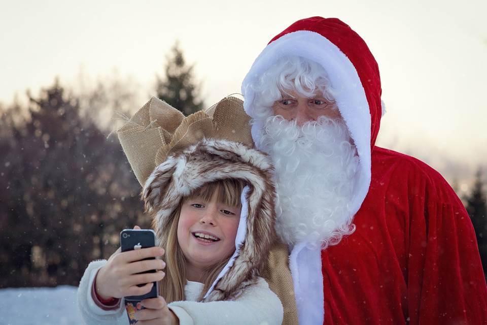Girl taking a selfie with Santa Claus