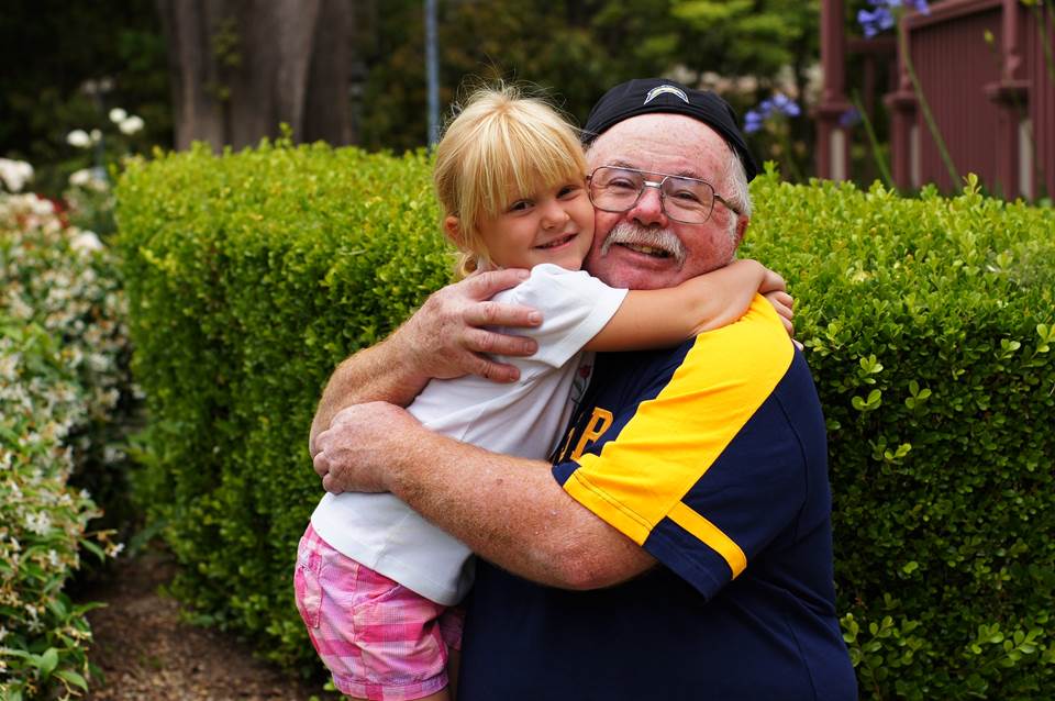 Granddaughter and grandfather hugging