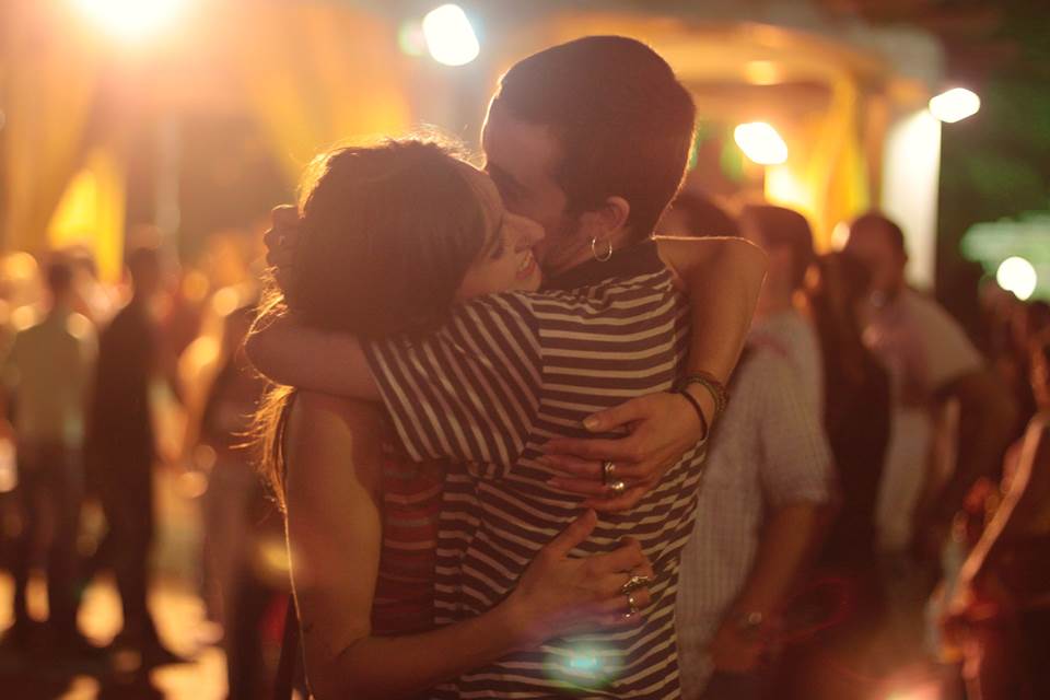 Young man and woman hugging at a party