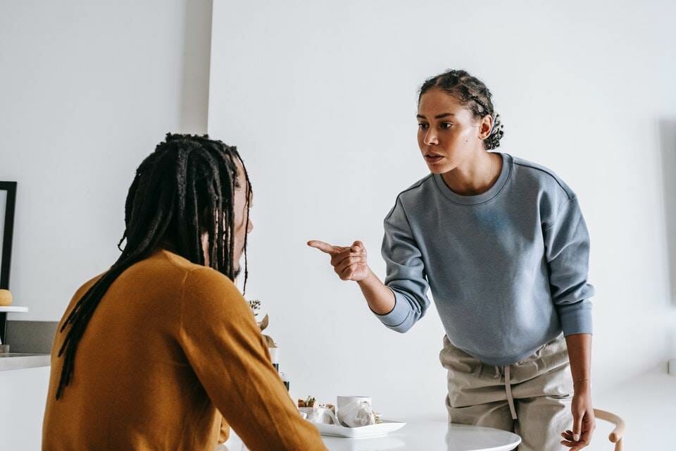 Woman pointing a blaming finger at man