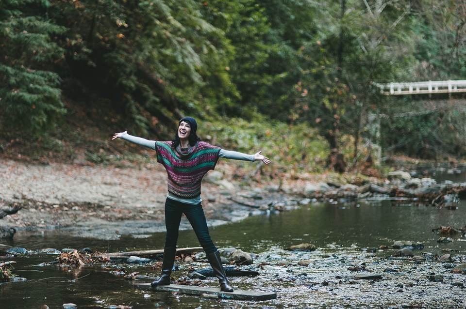 Young woman happy in the middle of a creek