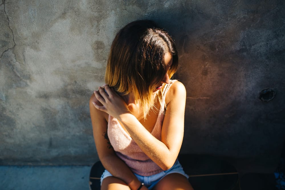 Teen with social anxiety sitting slone