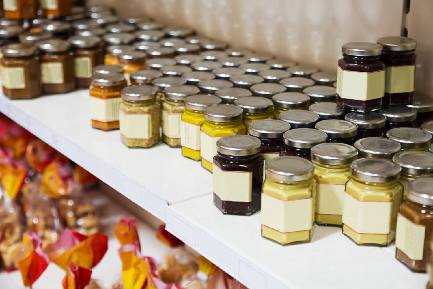 Grocery store shelf with dozens of jam jars, colorful, overwhelming choice