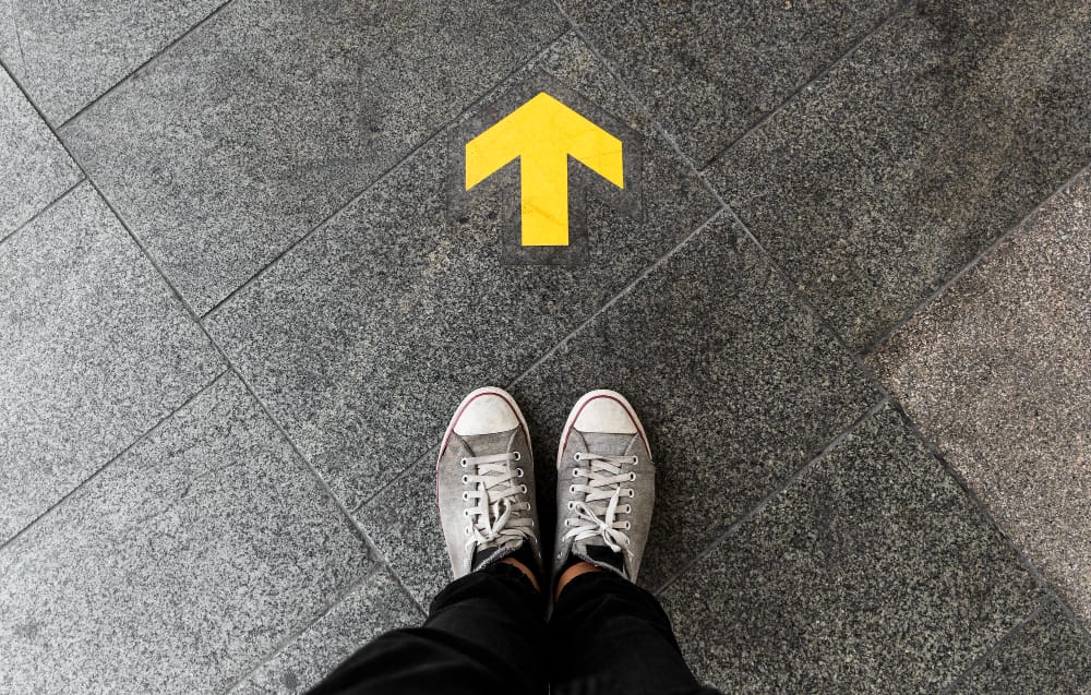 Forward arrow in front of person's feet - the illusion of free choice